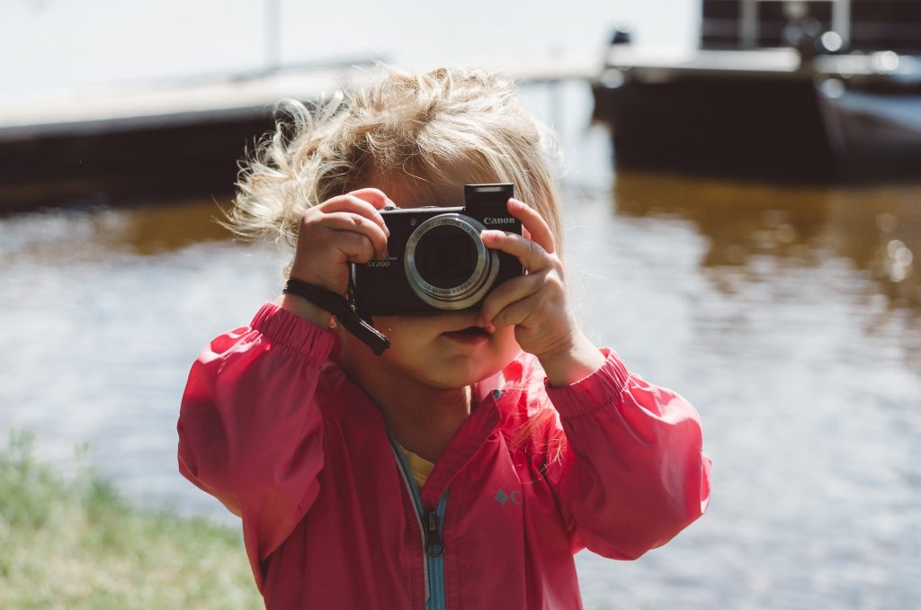 child holding a camera